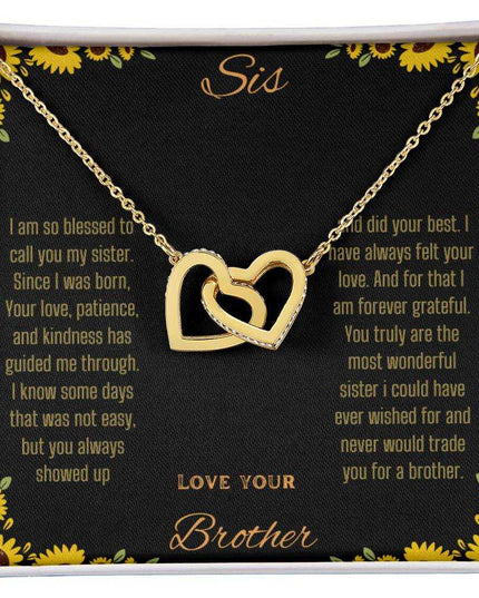 Interlocking Hearts Necklace with a gold variant on a To Sis from Brother greeting card up close