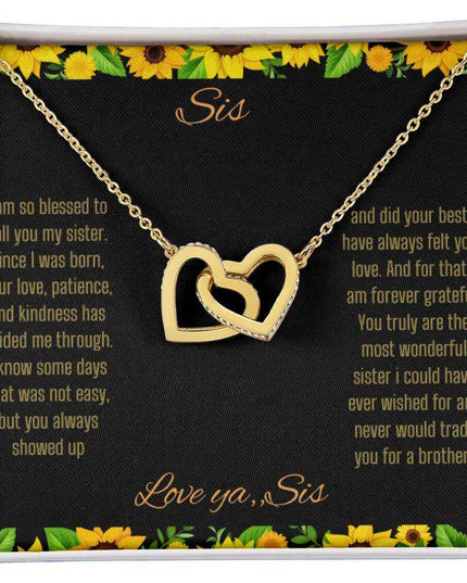 Interlocking Hearts Necklace with a gold on gold variant on a To Sis from Sis greeting card close up