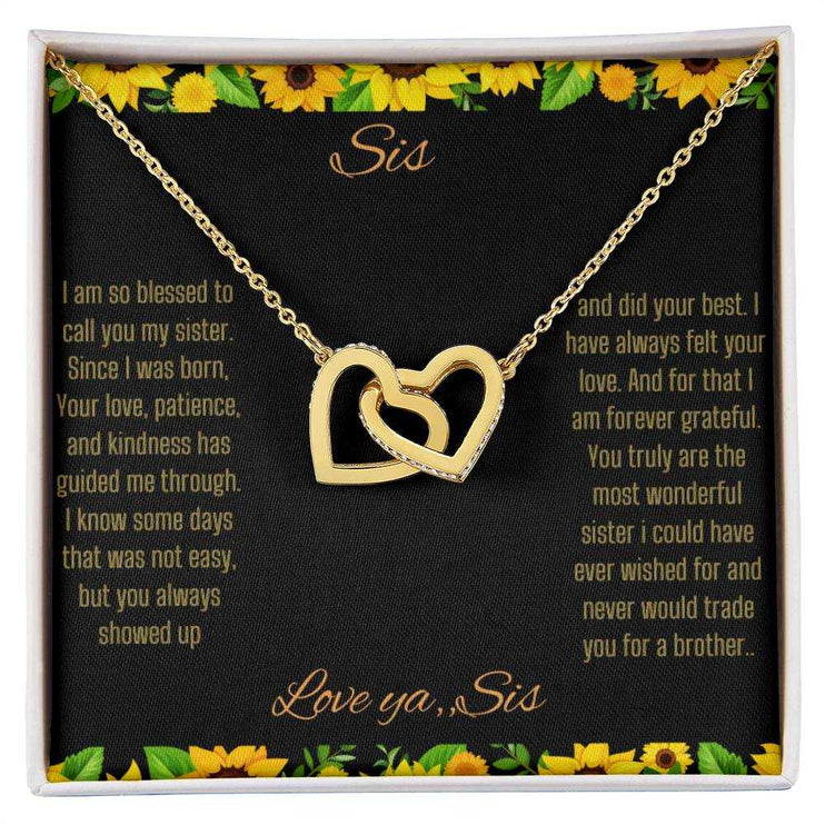 Interlocking Hearts Necklace with a gold on gold variant on a To Sis from Sis greeting card close up