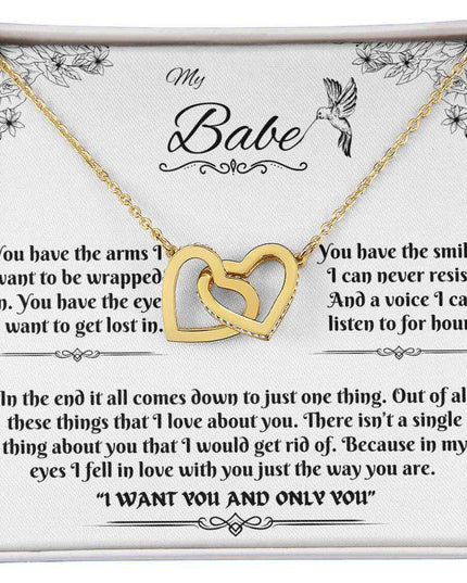 gold interlocking hearts necklace in a soft box up close