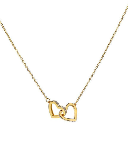 gold interlocking hearts necklace on white backdrop