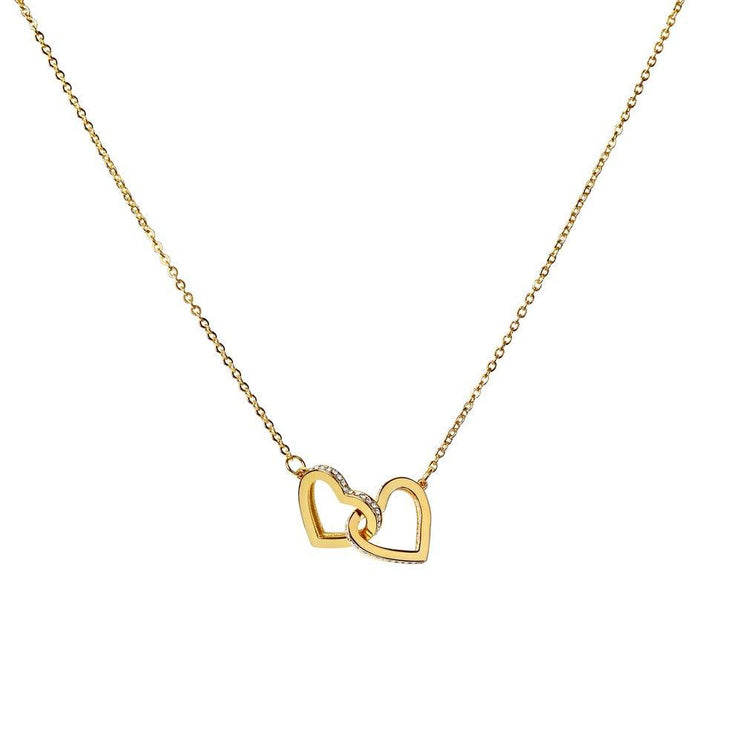 gold interlocking hearts necklace on white backdrop