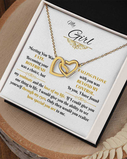 gold interlocking hearts necklace in soft box angled right