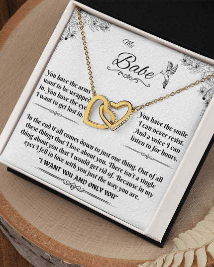 gold interlocking hearts necklace in a soft box angled to the right