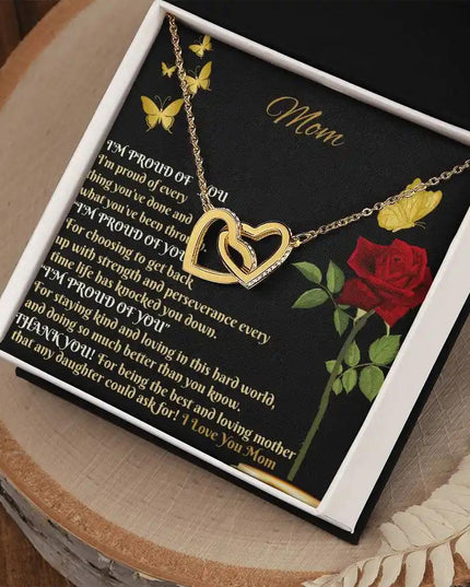 gold interlocking hearts necklace in a two-tone box angled right