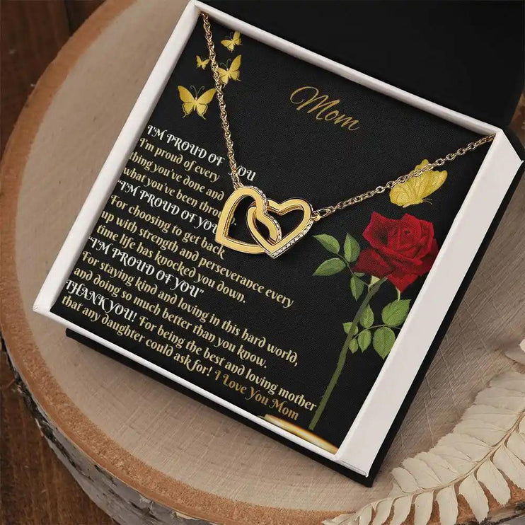 gold interlocking hearts necklace in a two-tone box angled right