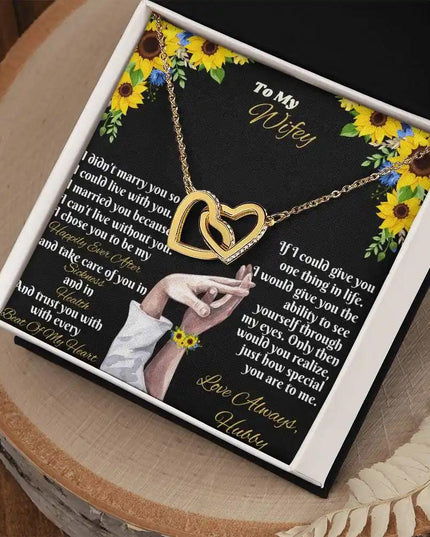 gold interlocking hearts necklace in two-tone box angled right
