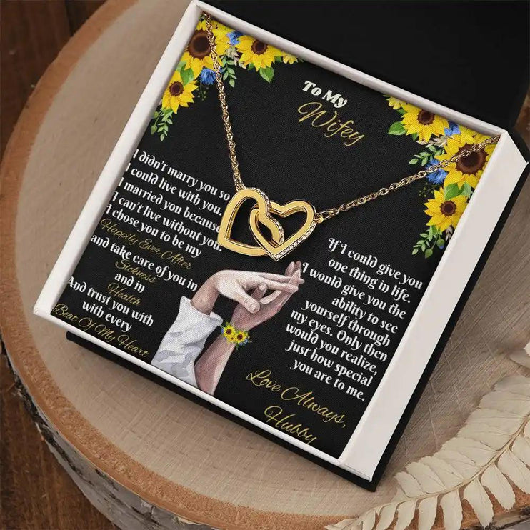 gold interlocking hearts necklace in two-tone box angled right