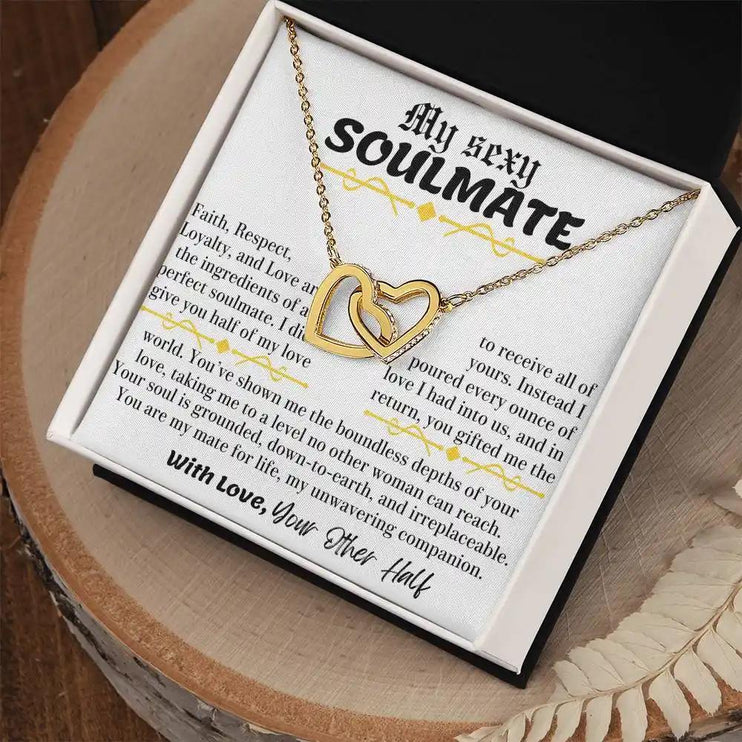 a yellow gold interlocking hearts necklace in a two-tone box angle right