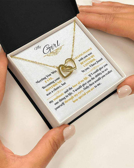 gold interlocking hearts necklace in soft box in model's hands