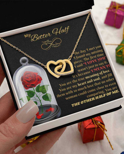 18k interlocking hearts necklace in a soft box in model's hand