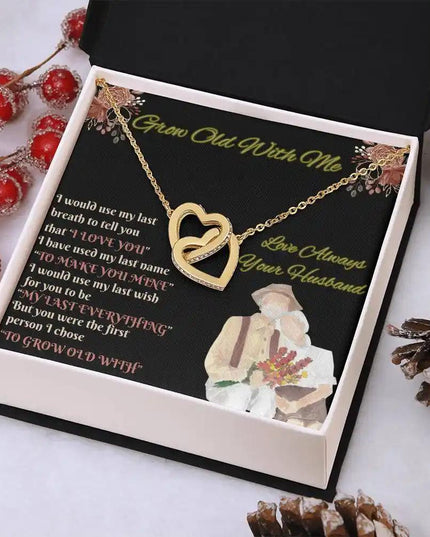 yellow gold interlocking hearts necklace in mahogany box angled right