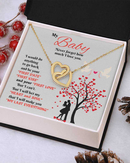 gold interlocking hearts necklace in a soft box angled right