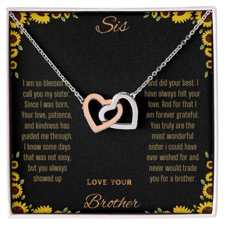 Interlocking Hearts Necklace with rose gold variant on a To Sis from Brother greeting card up close