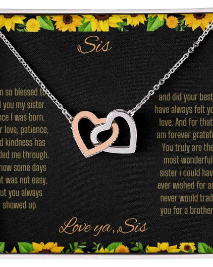 Interlocking Hearts Necklace with a rose gold variant on a To Sis from Sis greeting card close up