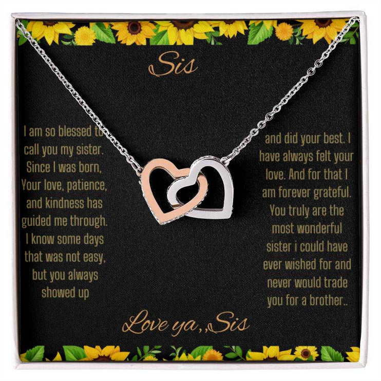 Interlocking Hearts Necklace with a rose gold variant on a To Sis from Sis greeting card close up