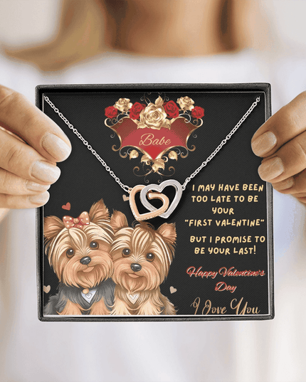 rose gold interlocking hearts necklace in a soft box in model's hands