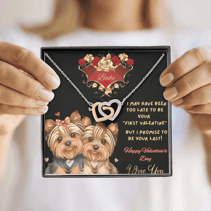 rose gold interlocking hearts necklace in a soft box in model's hands