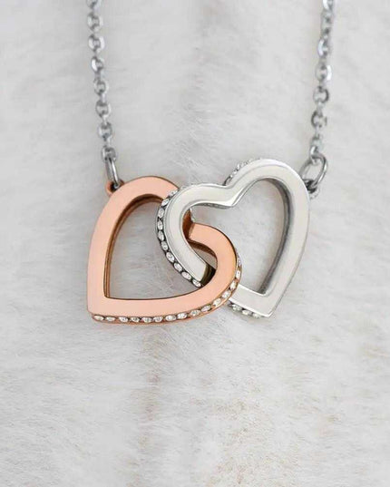 rose gold interlocking hearts necklace on a white felt background