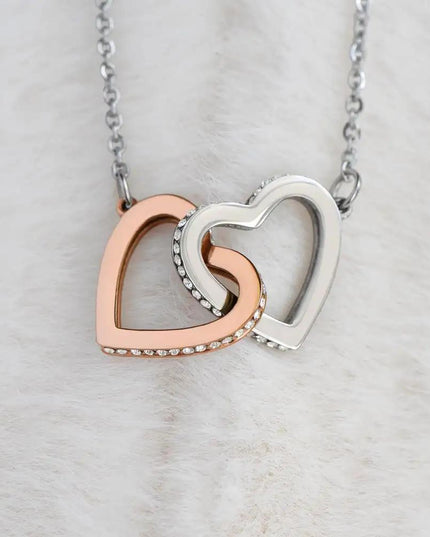 rose gold interlocking hearts necklace on a white fleece