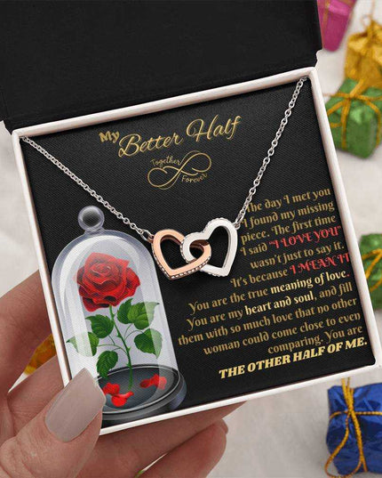 rose gold interlocking hearts necklace in soft box in model's hand