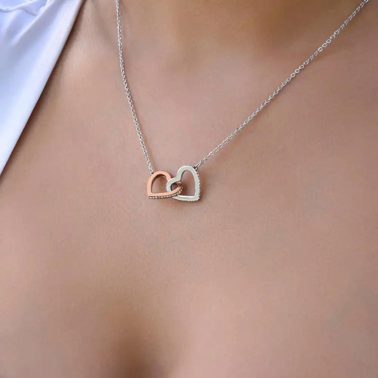 rose gold interlocking hearts necklace on model's neck