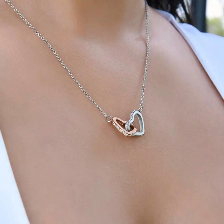 rose gold interlocking hearts necklace on models neck