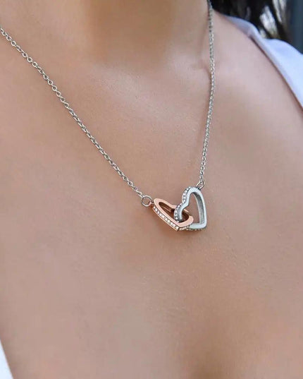 rose gold interlocking hearts necklace on a model's neck