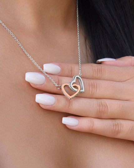 rose gold interlocking hearts necklace on a model's neck