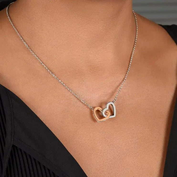 rose gold interlocking hearts necklace on a model's neck