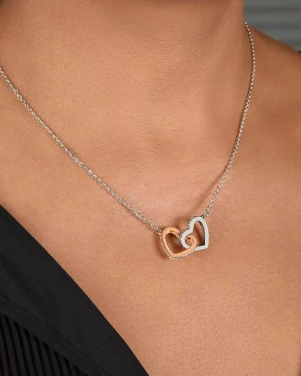 rose gold interlocking hearts necklace on model's neck