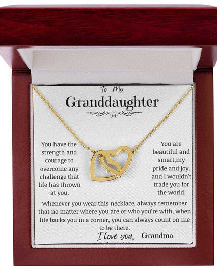 a yellow gold interlocking hearts necklace in a mahogany box