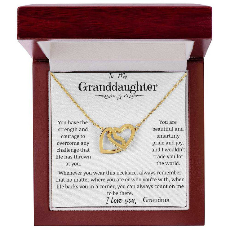 a yellow gold interlocking hearts necklace in a mahogany box