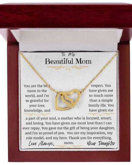 a yellow gold interlocking hearts necklace in a mahogany box