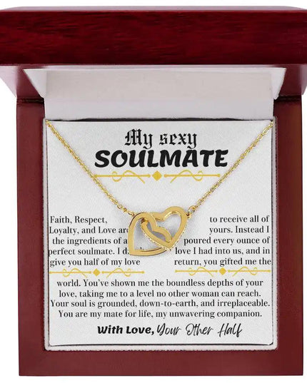 a yellow gold interlocking hearts necklace in a mahogany box