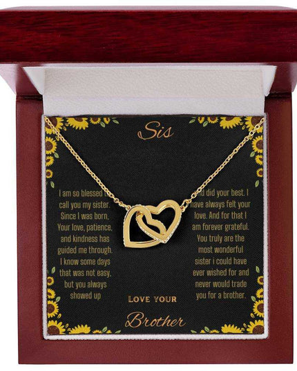 Interlocking Hearts Necklace with a gold variant on a To Sis from Brother greeting card inside a mahogany box 