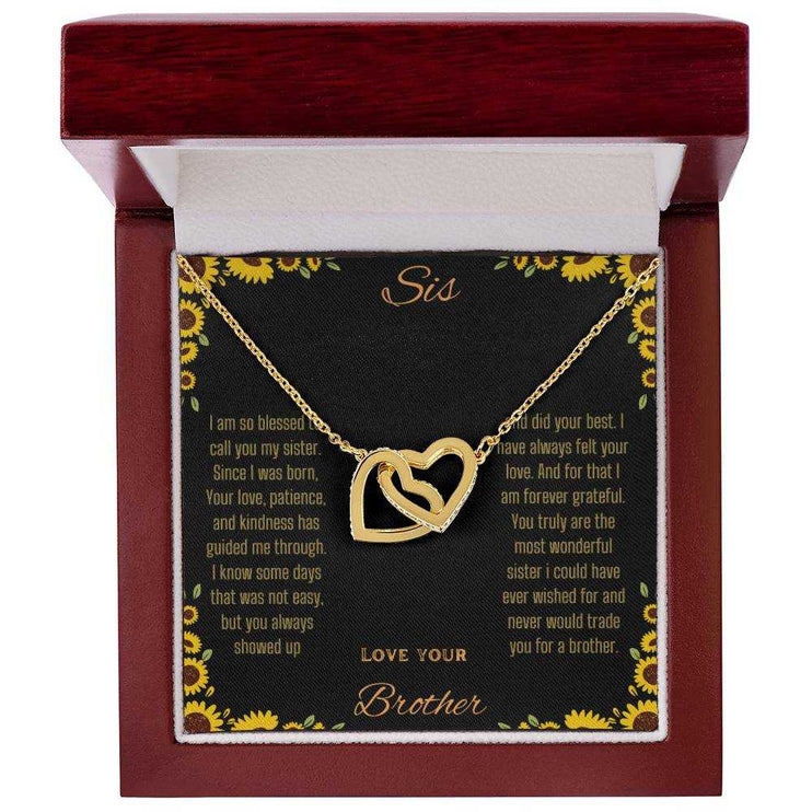 Interlocking Hearts Necklace with a gold variant on a To Sis from Brother greeting card inside a mahogany box 