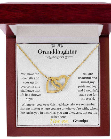 A yellow gold interlocking hearts necklace in a mahogany box