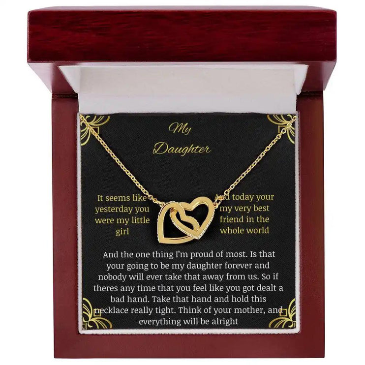Interlocking Hearts Necklace with a gold charm in a mahogany box angle 1
