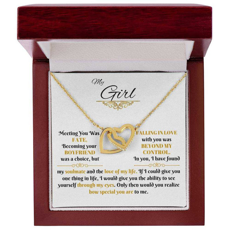 gold interlocking hearts necklace in a luxury box up close