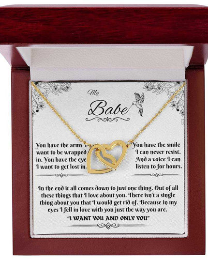 gold interlocking hearts necklace in a luxury box up close