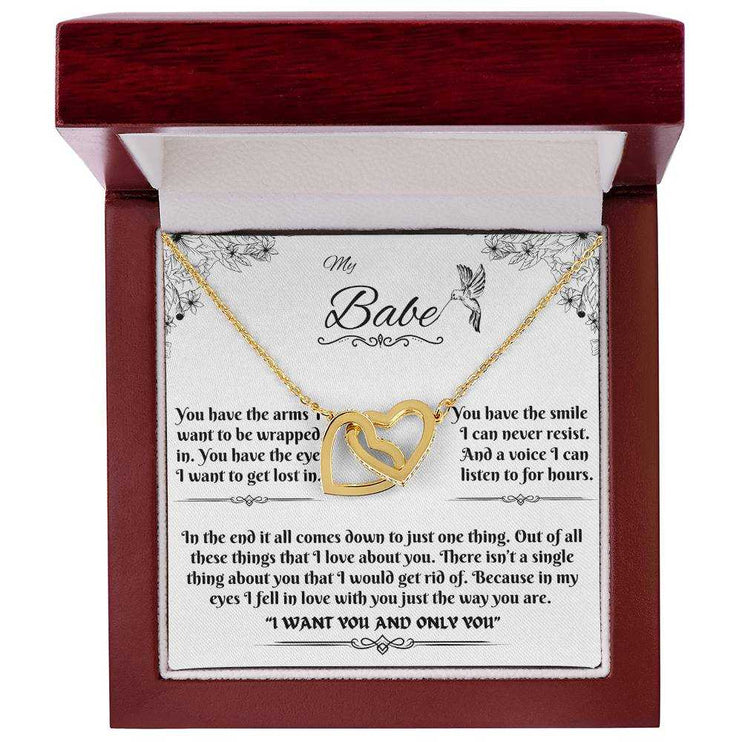 gold interlocking hearts necklace in a luxury box up close