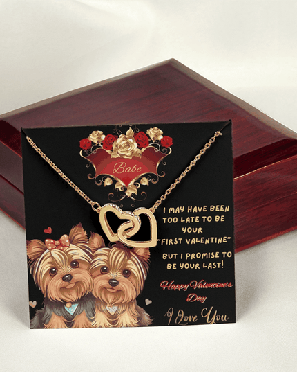 yellow gold interlocking hearts necklace outside of a luxury box on message card