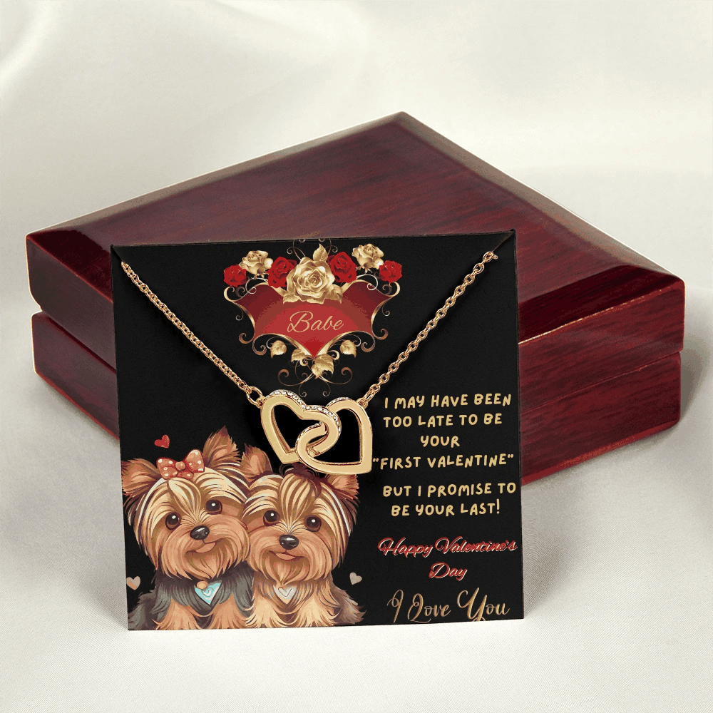 yellow gold interlocking hearts necklace outside of a luxury box on message card