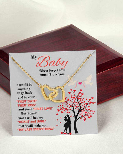 gold interlocking hearts necklace outside a closed luxury box