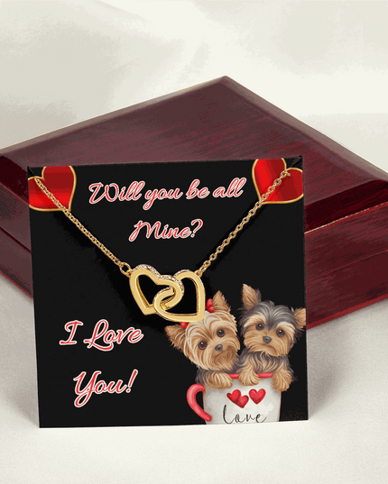 gold interlocking hearts necklace on a message card on a closed mahogany box