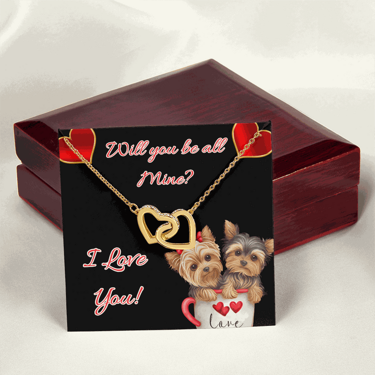 gold interlocking hearts necklace on a message card on a closed mahogany box