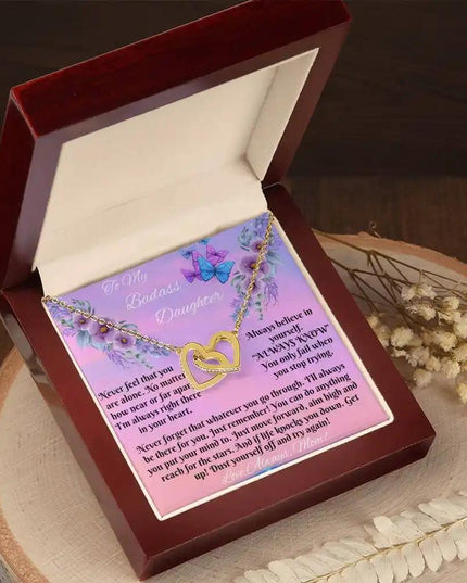 yellow gold interlocking hearts necklace in mahogany box angled left