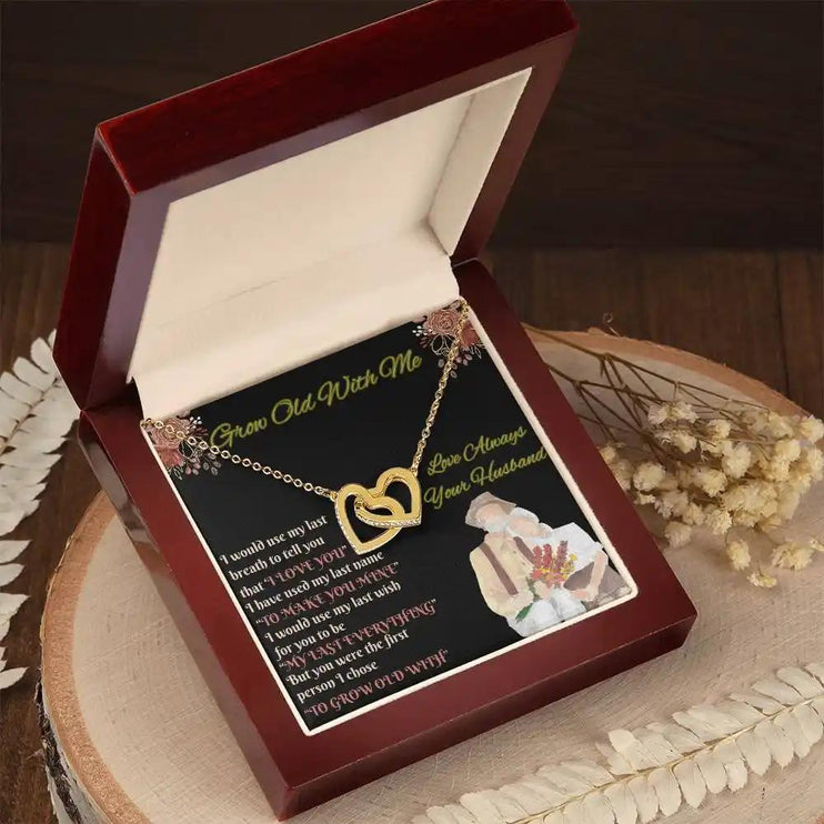 yellow gold interlocking hearts necklace in mahogany box angled left