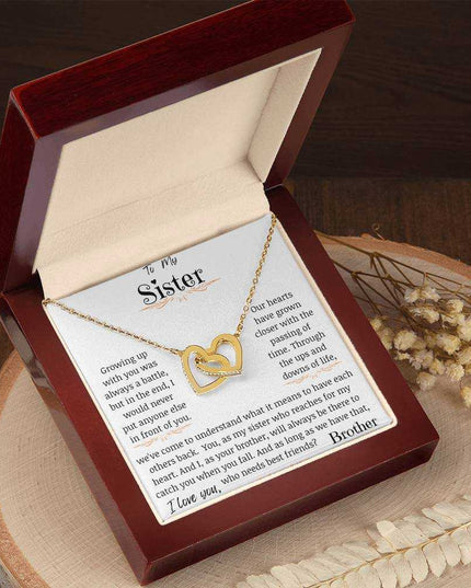 a yellow gold interlocking hearts necklace in a mahogany box